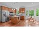 Bright kitchen featuring an island, eat-in nook, and large windows showcasing green outdoor views at 107 Candy Apple Ct, Cary, NC 27513