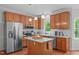 Spacious kitchen with a central island, stainless steel appliances, and plenty of natural light at 107 Candy Apple Ct, Cary, NC 27513