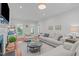 Bright living room features hardwood floors, plush furniture, and large windows overlooking a lush yard at 107 Candy Apple Ct, Cary, NC 27513