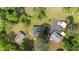 Aerial view of a residential property with multiple buildings and a large driveway at 108 Deepwood Cir, Garner, NC 27529