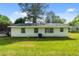 Back exterior with white siding, multiple windows, and air conditioning unit overlooking a spacious lawn at 108 Deepwood Cir, Garner, NC 27529