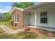 Charming house featuring a covered porch, classic brickwork, and well-maintained landscaping at 108 Deepwood Cir, Garner, NC 27529