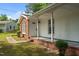 Charming home featuring a covered front porch, brick accents, and well-maintained landscaping at 108 Deepwood Cir, Garner, NC 27529