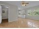 Open kitchenette area with tile flooring, white cabinets, and natural lighting at 108 Deepwood Cir, Garner, NC 27529