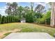 Spacious backyard with a shed, lush lawn, mature trees, and a wooden fence at 1209 Shasta Daisy Dr, Wake Forest, NC 27587
