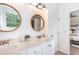 Bright bathroom with dual sinks, white cabinets, decorative mirrors, and modern fixtures at 1209 Shasta Daisy Dr, Wake Forest, NC 27587