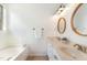 Bright bathroom with dual sinks, white cabinets, a soaking tub, and neutral color scheme at 1209 Shasta Daisy Dr, Wake Forest, NC 27587