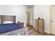 Comfortable bedroom features a wooden bed frame and matching wooden nightstand and dresser at 1209 Shasta Daisy Dr, Wake Forest, NC 27587