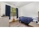 Bedroom featuring blue bedding, neutral walls, and a window providing natural light at 1209 Shasta Daisy Dr, Wake Forest, NC 27587