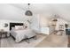 Bright bedroom with a queen-sized bed, modern lighting, sitting area, and neutral decor at 1209 Shasta Daisy Dr, Wake Forest, NC 27587