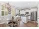 Eat-in kitchen features a wooden table, stainless steel appliances, and an island workspace at 1209 Shasta Daisy Dr, Wake Forest, NC 27587