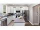 Well-lit kitchen boasts white cabinetry, stainless steel appliances, and subway tile backsplash at 1209 Shasta Daisy Dr, Wake Forest, NC 27587