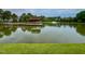 Scenic lake view showcases a gazebo with picnic tables and a fountain surrounded by mature trees at 1209 Shasta Daisy Dr, Wake Forest, NC 27587