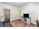 This living room features hardwood floors, an entertainment center, and neutral paint at 1209 Shasta Daisy Dr, Wake Forest, NC 27587