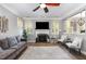 Comfortable living room showcasing a fireplace, hardwood floors, and natural light at 1209 Shasta Daisy Dr, Wake Forest, NC 27587