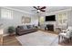Bright and airy living room with a fireplace, modern ceiling fan, and stylish decor at 1209 Shasta Daisy Dr, Wake Forest, NC 27587