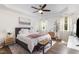 Bright main bedroom features a tray ceiling, ceiling fan, and large windows with natural light at 1209 Shasta Daisy Dr, Wake Forest, NC 27587