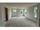 Bedroom with plush carpet, three large windows with natural light, and a walk-in closet at 1252 Randwick Vly Ct, Zebulon, NC 27597