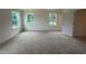 Spacious bedroom with plush carpeting and natural light from the double windows at 1252 Randwick Vly Ct, Zebulon, NC 27597
