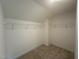Walk-in closet featuring neutral carpet and wall-mounted shelving at 1252 Randwick Vly Ct, Zebulon, NC 27597