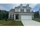 Charming two-story home with brick accents, a two-car garage, and a well-maintained front lawn at 1252 Randwick Vly Ct, Zebulon, NC 27597