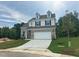 Charming two-story home with neutral brick and siding, and an attached two-car garage at 1252 Randwick Vly Ct, Zebulon, NC 27597