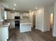 Bright kitchen featuring white cabinetry, stainless steel appliances, and an island with a quartz countertop at 1252 Randwick Vly Ct, Zebulon, NC 27597