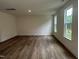 Spacious living room with hardwood floors, recessed lighting, and large windows offering plenty of natural light at 1252 Randwick Vly Ct, Zebulon, NC 27597