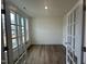 Office featuring hardwood floors and glass doors for privacy at 1252 Randwick Vly Ct, Zebulon, NC 27597