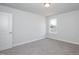 An inviting bedroom with neutral walls, plush carpet, and plenty of natural light at 127 High Hampton Way, Fuquay Varina, NC 27526