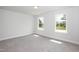 A serene bedroom with plush carpeting, large windows and neutral tones at 127 High Hampton Way, Fuquay Varina, NC 27526