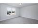 Bright, carpeted bedroom with view of new construction from large window at 127 High Hampton Way, Fuquay Varina, NC 27526
