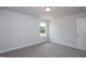 A light-filled bedroom featuring plush carpeting and a view to the outdoors at 127 High Hampton Way, Fuquay Varina, NC 27526