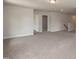 Spacious, carpeted bonus room with neutral walls and ample natural light, perfect for versatile living space at 127 High Hampton Way, Fuquay Varina, NC 27526