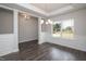 Dining area with hardwood floors, large windows, and a chandelier, offering ample space at 127 High Hampton Way, Fuquay Varina, NC 27526