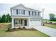 Beautiful two-story home with gray siding, stone accents, and a manicured lawn at 127 High Hampton Way, Fuquay Varina, NC 27526