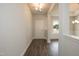 Entryway with a white door, wood floors, and view into living and dining areas at 127 High Hampton Way, Fuquay Varina, NC 27526