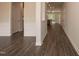 Bright hallway with dark wood floors, white trim, and doorways leading to other rooms at 127 High Hampton Way, Fuquay Varina, NC 27526