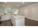 Spacious kitchen with white cabinets, granite countertops, and stainless steel appliances at 127 High Hampton Way, Fuquay Varina, NC 27526