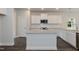 Bright kitchen features white cabinets, stainless appliances, granite countertops, and a central island at 127 High Hampton Way, Fuquay Varina, NC 27526