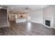 Open-concept layout of the living room, kitchen and stairway features wood flooring and a fireplace at 127 High Hampton Way, Fuquay Varina, NC 27526