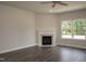 Inviting living room with a fireplace, large windows, and hardwood floors at 127 High Hampton Way, Fuquay Varina, NC 27526