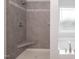 Modern gray tiled shower with a built-in bench seat and decorative mosaic tile accents at 127 High Hampton Way, Fuquay Varina, NC 27526
