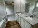 Bathroom featuring dual sinks, granite countertops, and tub at 127 Oakfield Trace Dr, Four Oaks, NC 27524
