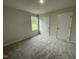 Bedroom with carpet, a window, and two doors at 127 Oakfield Trace Dr, Four Oaks, NC 27524