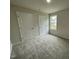 Bedroom with carpet, a window, and two doors at 127 Oakfield Trace Dr, Four Oaks, NC 27524