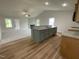 Open concept kitchen with an island, granite countertops, stainless appliances, and view to living area at 127 Oakfield Trace Dr, Four Oaks, NC 27524