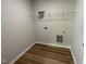 A bright laundry room with wood grain flooring and wire shelving at 127 Oakfield Trace Dr, Four Oaks, NC 27524