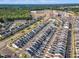 An aerial shot shows a residential area near a pool, businesses, and a lush forest area at 1272 Brown Velvet Ln, Apex, NC 27523