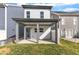 View of patio and backyard showing the covered space and lush lawn at 1272 Brown Velvet Ln, Apex, NC 27523